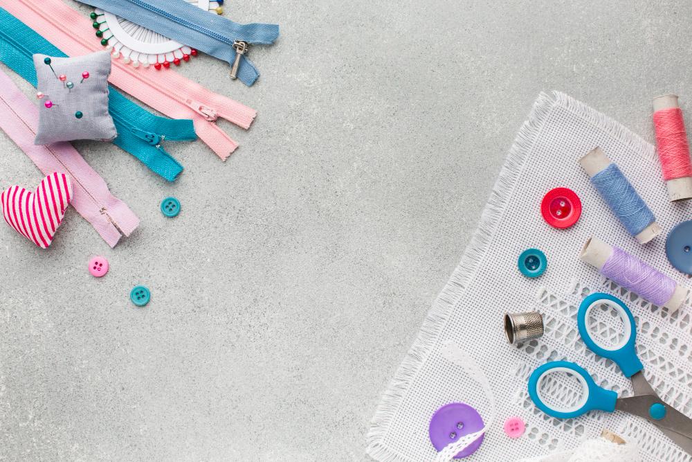 Sewing notions including zips, buttons, thread, pins, a thimble and scissors
