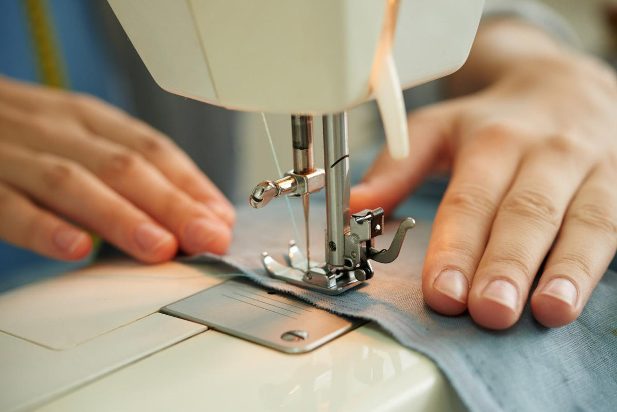 Running stitch sewn by hand next to a machine straight stitch